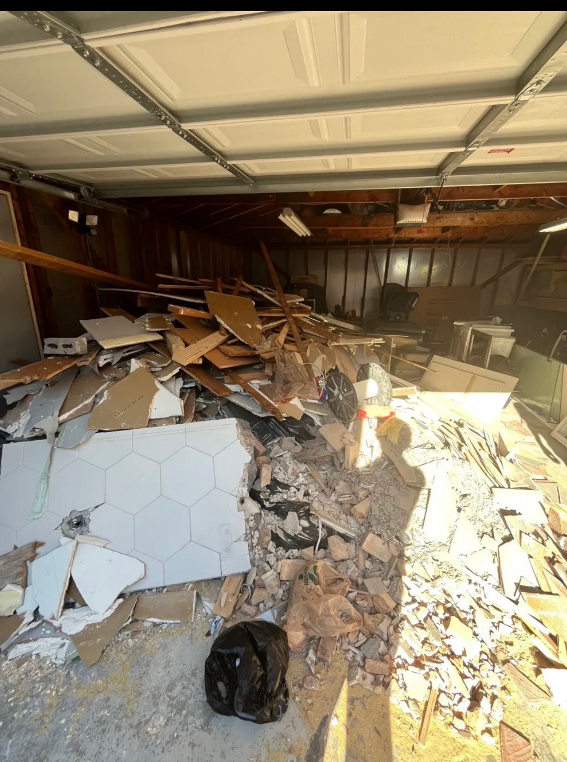 Garage cleanout in Chicago — before, garage full of junk and old insulation